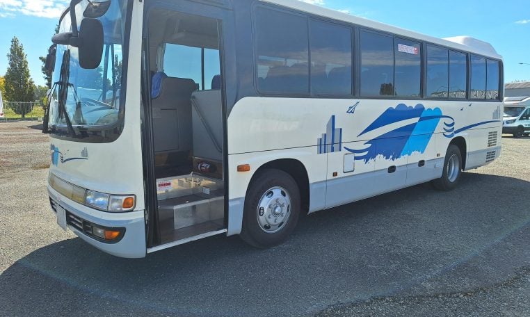 2012 Hino Melpha exterior view of the passenger entry door.