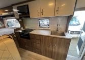 2017 Jayco Conquest FA24-1 interior view showing the central kitchen with stovetop.