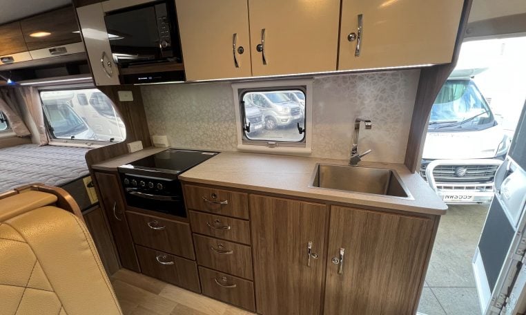2017 Jayco Conquest FA24-1 interior view showing the central kitchen with stovetop.