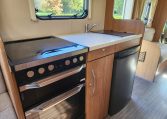 2018 Auto-Trail Imala 720 motorhome interior view of the kitchen showcasing the hobb, oven and fridge.