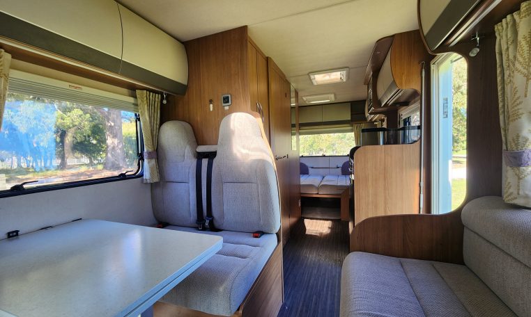 2018 Auto-Trail Imala 720 motorhome interior view showing the rear lounge converted into a bed.