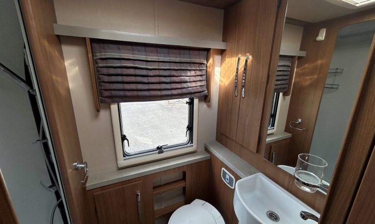 2018 Auto-Trail Tracker RS motorhome interior view of the bathroom showing the shower, handbasin and toilet.