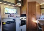 2018 Auto-Trail Tribute 715 motorhome interior view showing the microwave and fridge in the kitchen.
