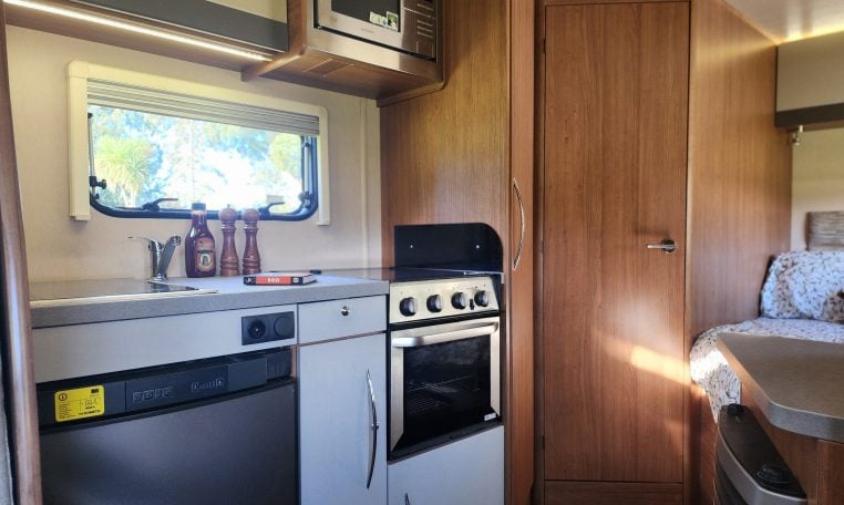 2018 Auto-Trail Tribute 715 motorhome interior view showing the microwave and fridge in the kitchen.