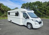 Side view of a 2018 Bailey Autograph 79-4T motorhome showing the driver's door.