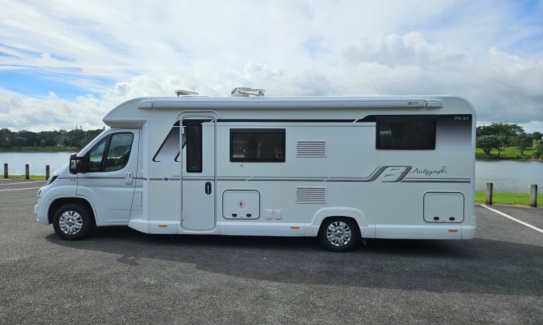 Side view of a 2018 Bailey Autograph 79-4T motorhome showing the habitation door and camper exterior.