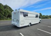 Rear-side view of the 2018 Bailey Autograph 79-4T motorhome displaying exterior design, taillights, and side profile.