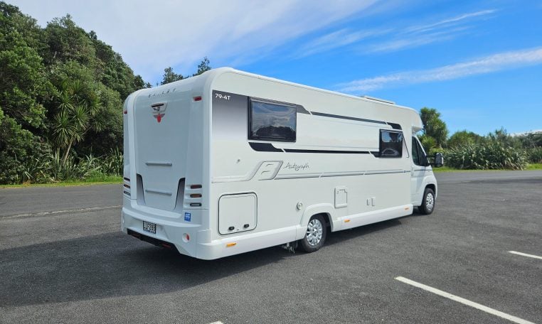 Rear-side view of the 2018 Bailey Autograph 79-4T motorhome displaying exterior design, taillights, and side profile.