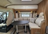 Front dining area in a 2018 Bailey Autograph 79-4T motorhome with seating and table.