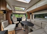 Interior view of the 2018 Bailey Autograph 79-4T motorhome living area with seating and table.