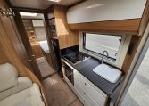 Compact 2018 Bailey Autograph 79-4T motorhome kitchen with fridge, oven and smart storage cupboards.