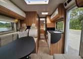 Interior view of the 2018 Bailey Autograph 79-4T motorhome living area with seating and table.