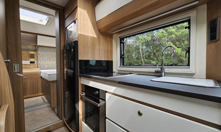 2018 Bailey Autograph 79-4T motorhome kitchen with fridge, oven and storage cupboards in a compact, practical layout