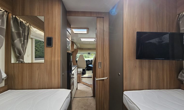 TV mounted inside the 2018 Bailey Autograph 79-4T motorhome rear bedroom area.