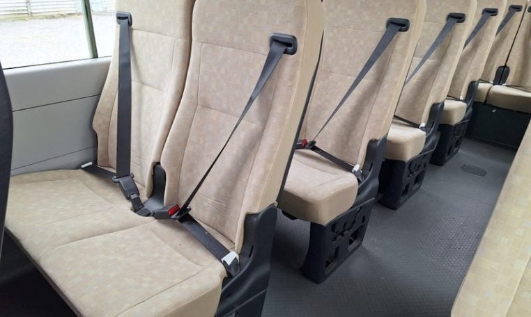 Toyota Coaster bus passenger seatbelts fitted to seating area for safe and secure travel