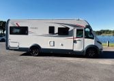 2018 Roller Team Pegaso 745 exterior showing the driver's side profile next to the lake.