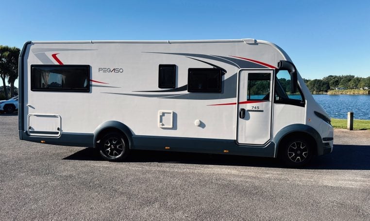 2018 Roller Team Pegaso 745 exterior showing the driver's side profile next to the lake.