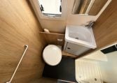 2018 Roller Team Pegaso 745 interior showing the toilet and sink in the bathroom.