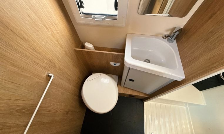2018 Roller Team Pegaso 745 interior showing the toilet and sink in the bathroom.