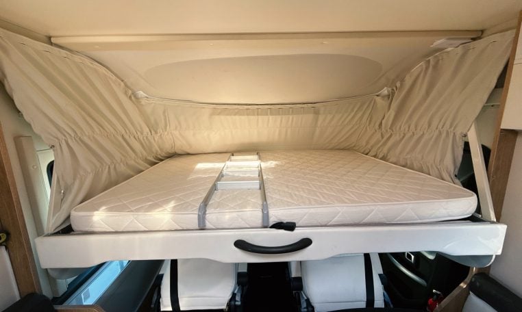 2018 Roller Team Pegaso 745 interior with drop-down bed and ladder.