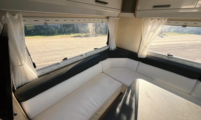 2018 Roller Team Pegaso 745 interior rear U-shaped lounge seating and windows