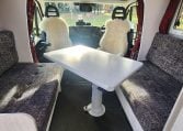 2019 Iveco Daily 50-210 interior view showing the spacious front lounge and dining table.