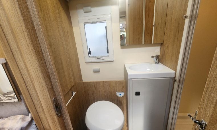 2019 Roller Team T-Line 785 interior view showing the bathroom with toilet and handbasin.