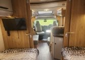 2019 Roller Team T-Line 785 interior view showing the TV in the bedroom.