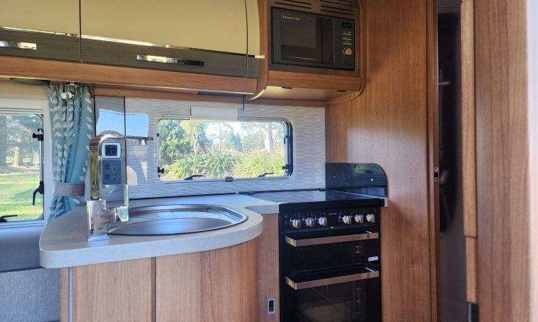 2020 Auto-Trail Delaware interior showing the kitchen with oven and grill.