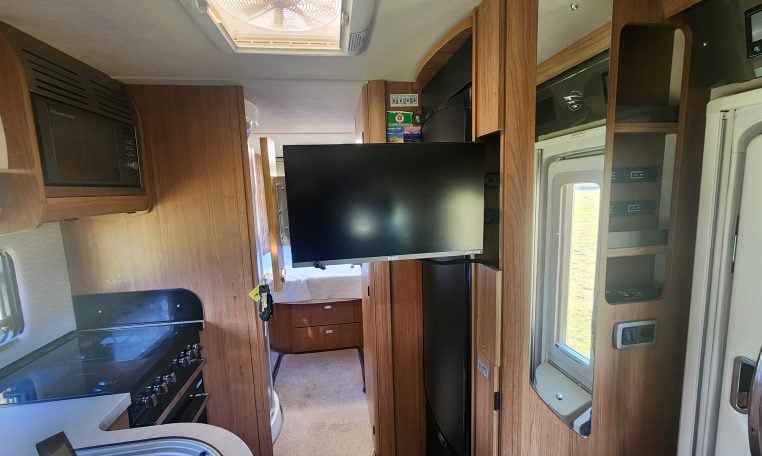 2020 Auto-Trail Delaware interior showing the slide out TV.