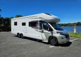 Side view of an Auto-Trail Frontier Comanche motorhome showing the driver's door.