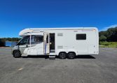 Side view of an Auto-Trail Frontier Comanche motorhome showing the habitation door and camper exterior.