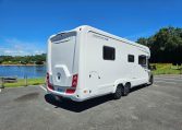 Rear side view of an Auto-Trail Frontier Comanche motorhome showing the camper exterior.