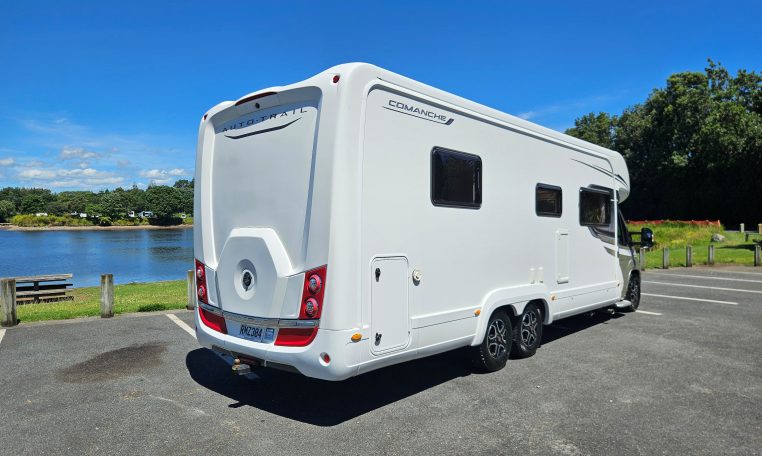 Rear side view of an Auto-Trail Frontier Comanche motorhome showing the camper exterior.