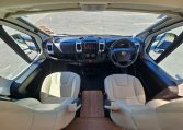 Interior view of the Auto-Trail Frontier Comanche motorhome cab with dashboard, seating, and controls.