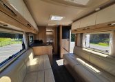 Auto-Trail Frontier Comanche motorhome interior with overhead cabinets providing convenient storage above seating.