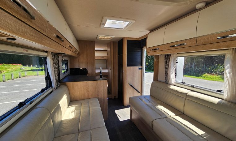 Auto-Trail Frontier Comanche motorhome interior with overhead cabinets providing convenient storage above seating.