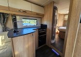 Interior view of the Auto-Trail Frontier Comanche motorhome kitchen with sink, hob, and compact layout.