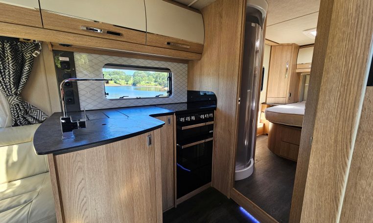 Interior view of the Auto-Trail Frontier Comanche motorhome kitchen with sink, hob, and compact layout.