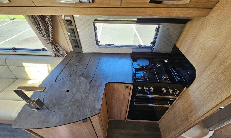 Stove and oven in the Auto-Trail Frontier Comanche motorhome kitchen for convenient cooking while traveling.