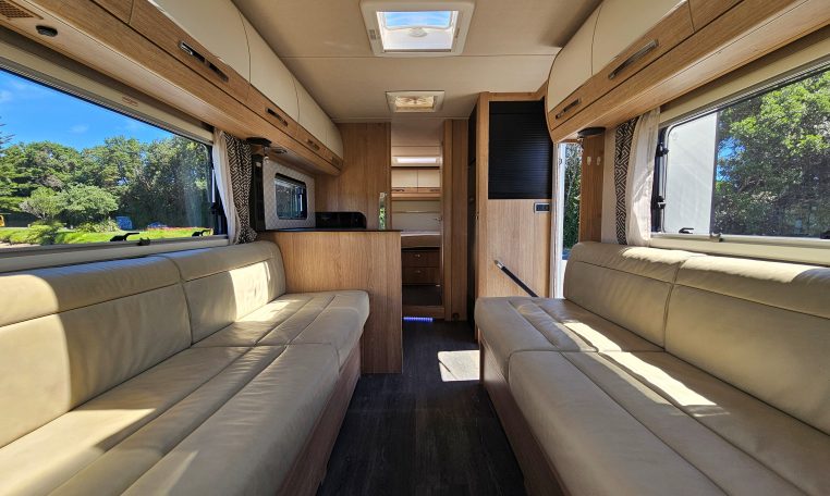 Interior view of the Auto-Trail Frontier Comanche motorhome looking from the front towards the rear, showing kitchen and lounge layout.