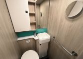 2021 Auto-Trail F-Line F74 interior view showing the compact motorhome bathroom with toilet and handbasin.