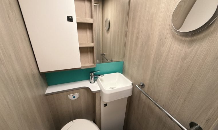 2021 Auto-Trail F-Line F74 interior view showing the compact motorhome bathroom with toilet and handbasin.
