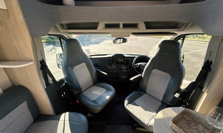 2021 Auto-Trail F-Line F74 interior view showing the cab swivel seats providing more seating in the lounge.