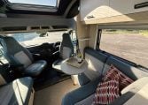 2021 Auto-Trail F-Line F74 interior view showing the swivel arm table in the front lounge.