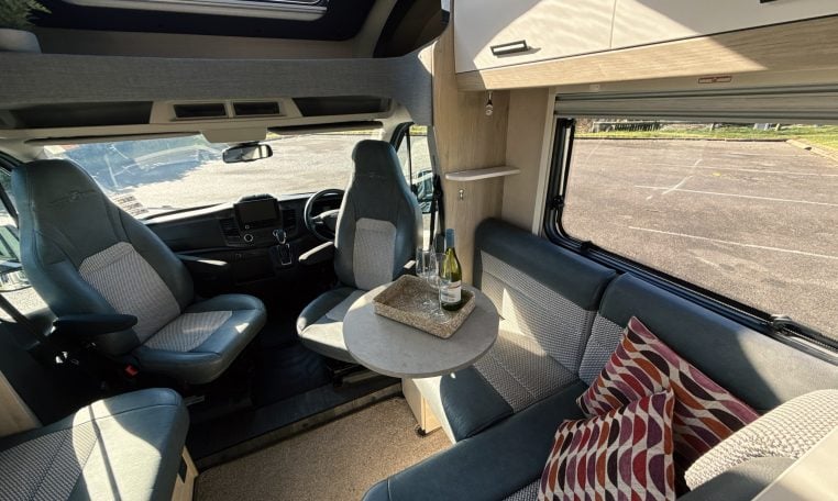 2021 Auto-Trail F-Line F74 interior view showing the swivel arm table in the front lounge.