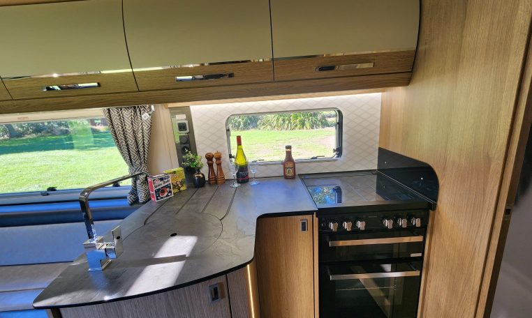 2021 Auto-Trail Frontier Comanche motorhome interior view of the kitchen with hob and oven.