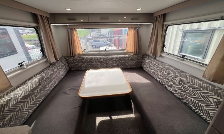 2021 Jayco Conquest FA24-4 interior view of the rear lounge with dining table.