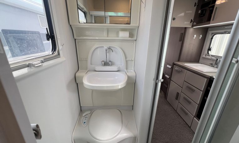 2021 Jayco Conquest FA24-4 interior view of the compact toilet and handbasin.