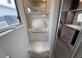 2021 Jayco Conquest FA24-4 interior view of the compact toilet and handbasin lifted up.